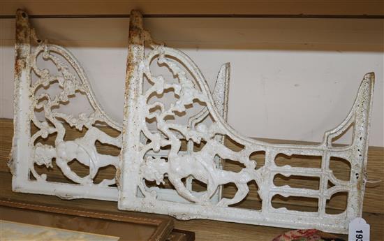 A pair of painted cast iron brackets height 42cm